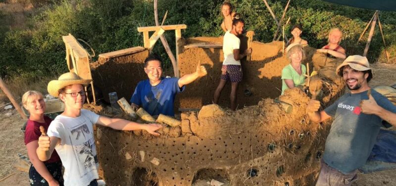 workshop students building a cob cottage during a Natural Building Workshop in Portugal